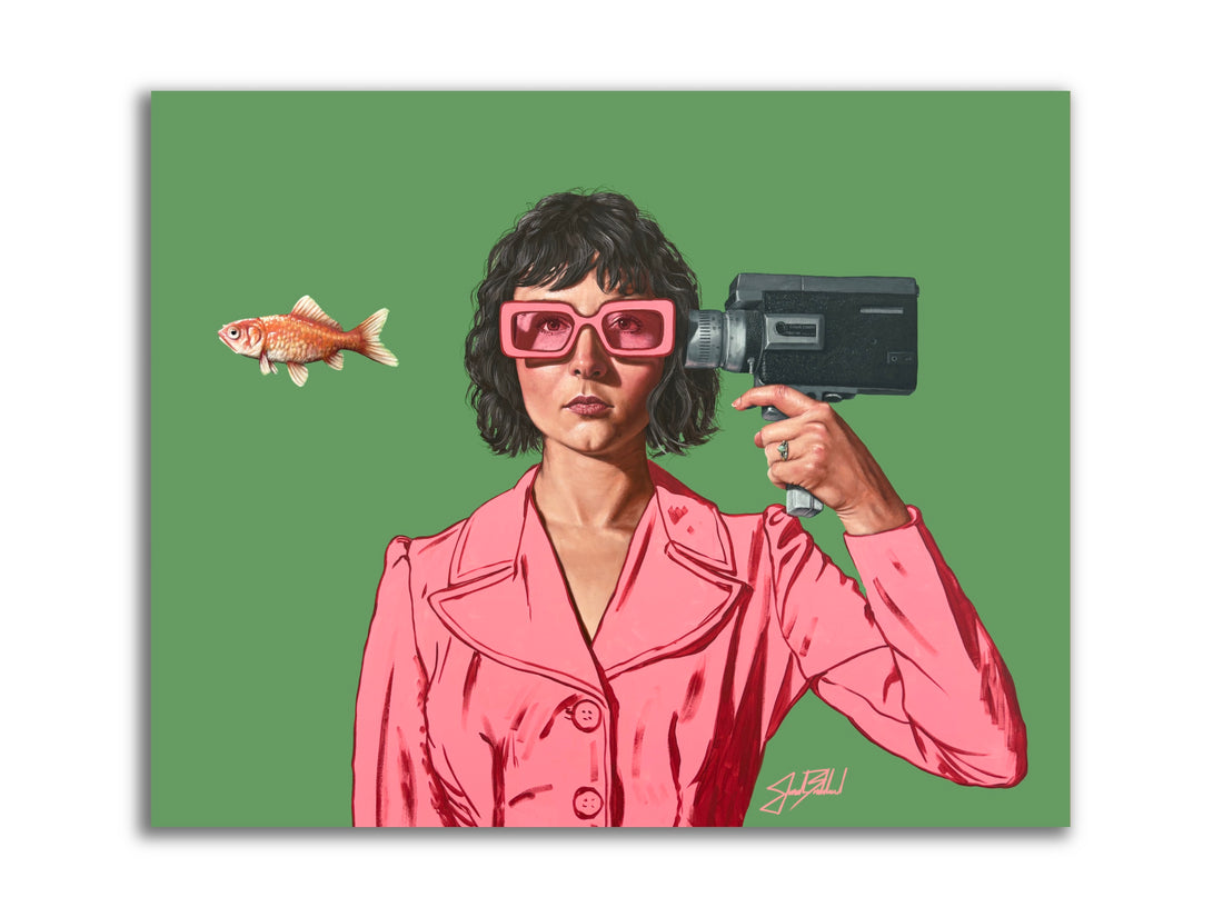 A stylized paper print of a woman in a pink suit holding a video camera with a goldfish floating in front of her.