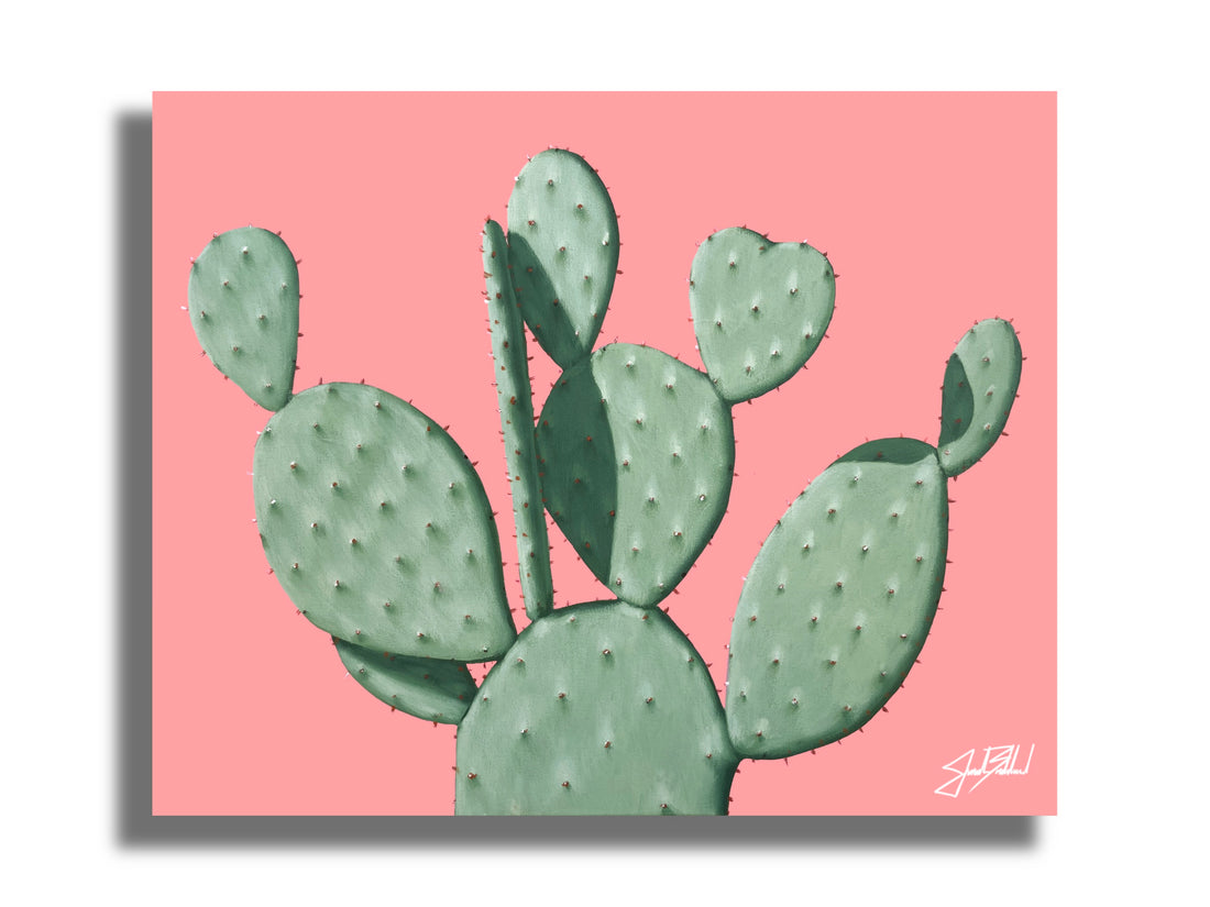 A paper print of a green prickly pear cactus on a pink background, signed by Jonah Ballard