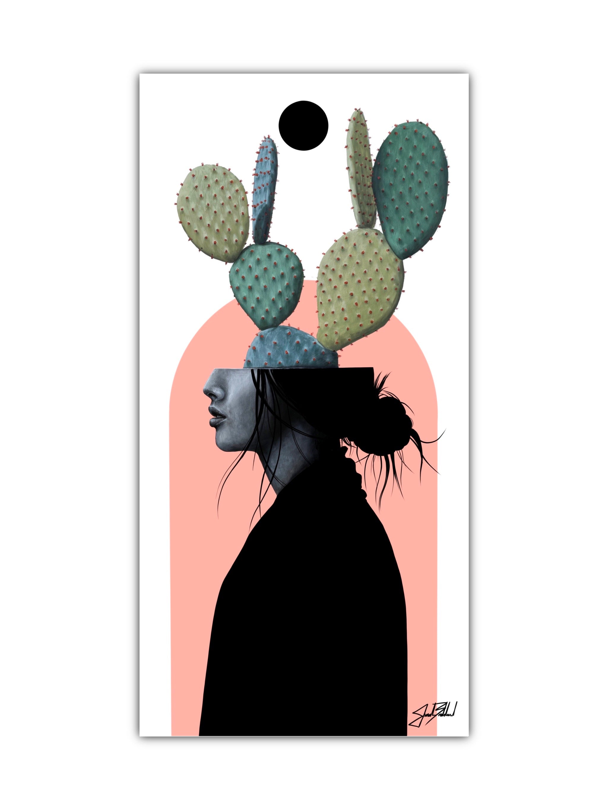 Artistic paper print depicting a stylized female figure with cactus elements in her hair, set against a pink background. The print is framed and signed by Jonah Ballard