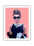 A paper print of a woman wearing sunglasses and a pearl necklace, holding a coffee cup, on a pink background.