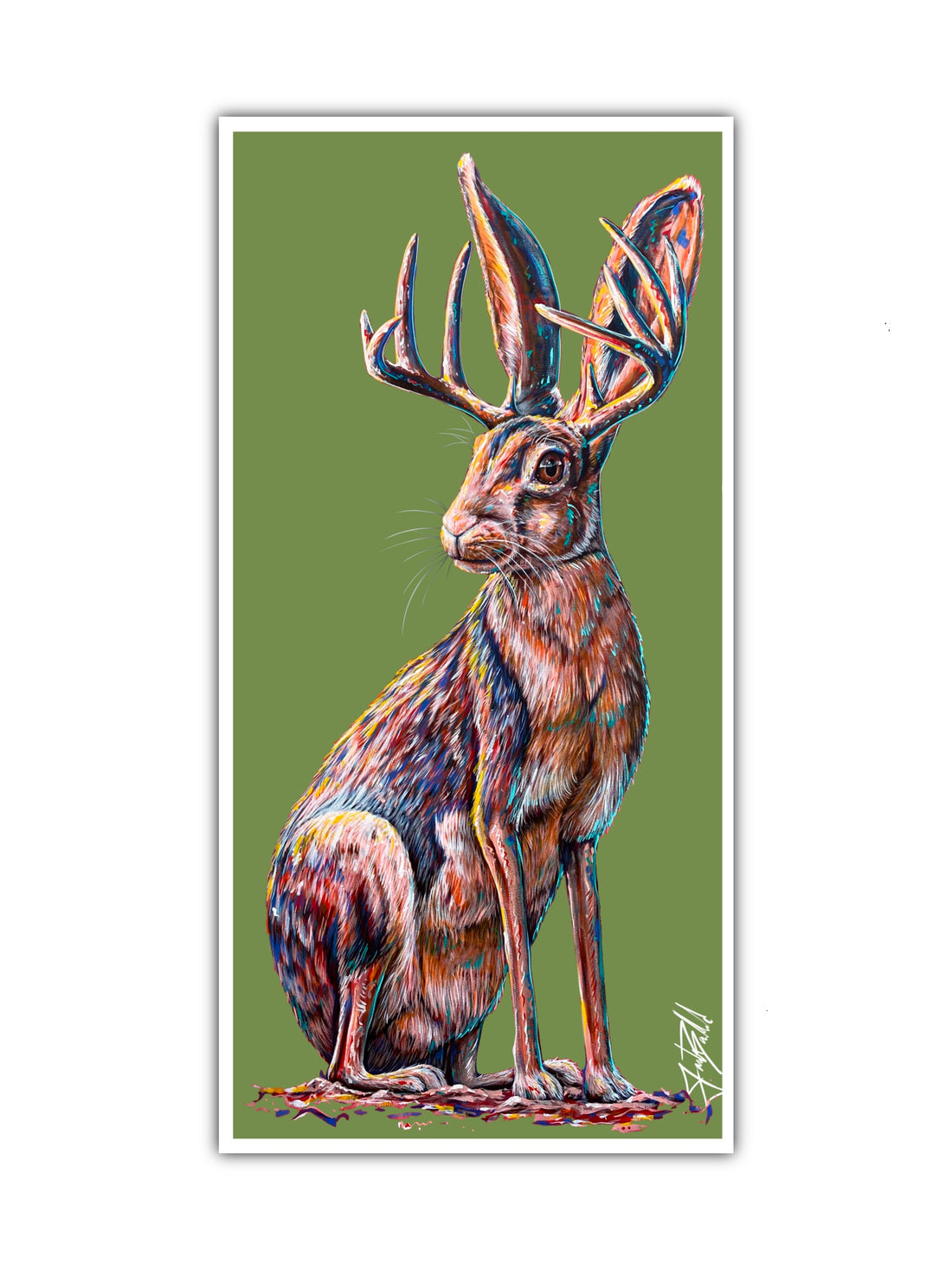 A colorful paper print of a jackalope with antlers, displayed against a green background.